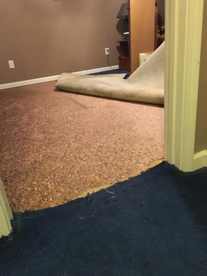 Carpet pad removal revealing water damage during Drying & Dehumidification in Sergeant Bluff